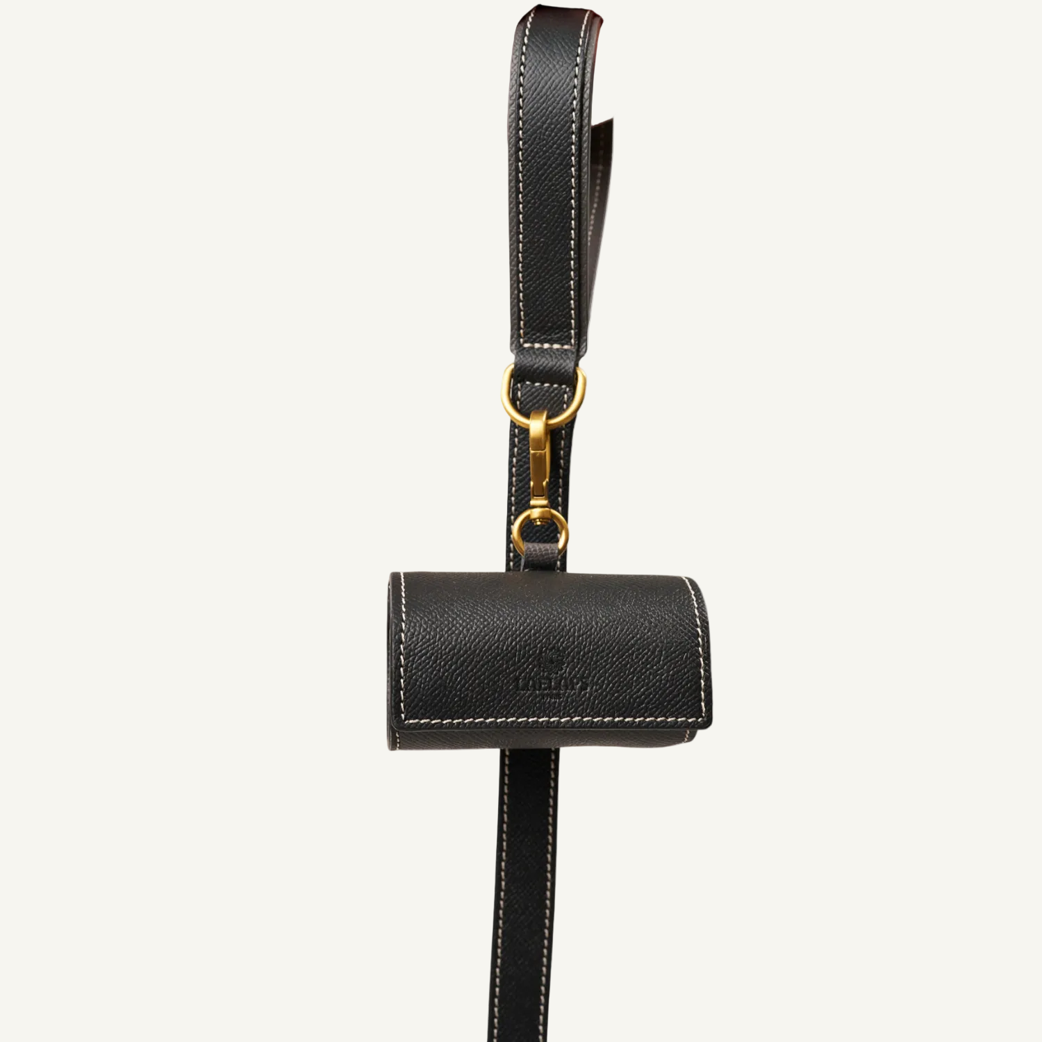 lack leather waste bag holder  with  gold hardware held by a hand on a white background