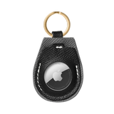 Black leather AirTag holder with gold hardware by Laelaps Paris