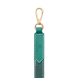 Close-up of green leather dog leash with gold clasp