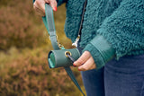 Matching green leather leash with waste bag holder from Laelaps Paris