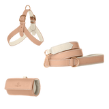 Powder pink leather dog harness, leash and poop bag holder set with off-white lining and matte rose gold hardware from Laelaps Paris