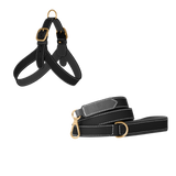 Black embossed calf leather dog harness and matching leash with grey lining, white stitching and matte gold buckles by Laelaps Paris