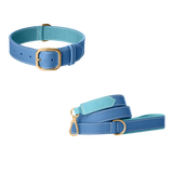 Blue  leather dog collar and matching leash with light blue lining, white stitching and brushed gold buckle by Laelaps Paris