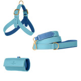 Light blue leather dog harness, leash and poop bag holder set with royal blue lining and matte gold hardware from Laelaps Paris
