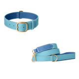 Light blue leather dog collar and matching leash with blue lining, white stitching and brushed gold buckle by Laelaps Paris