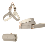 Light grey leather dog harness, leash and poop bag holder set with off-white lining and matte rose gold hardware from Laelaps Paris